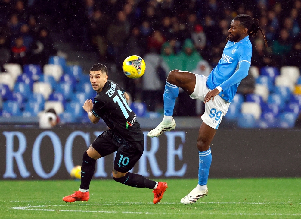 Lazio’s Mattia Zaccagni in action with Napoli’s Frank Anguissa. — Reuters pic