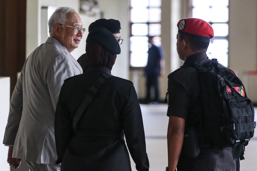 Former prime minister Datuk Seri Najib Razak is escorted by prison guards as he arrives at the Kuala Lumpur High Court Complex December 10, 2024. — Picture by Yusof Mat Isa