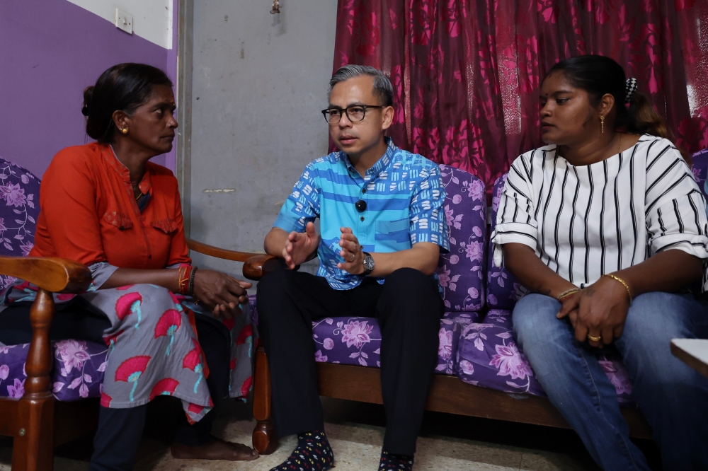 Communications Minister Fahmi Fadzil is seen during a visit to hand over personal donations to PR Puspa, the mother of the late social media influencer A. Rajeswary, or Esha, at her home in Bandar Baru Ampang August 18, 2024. — Bernama pic