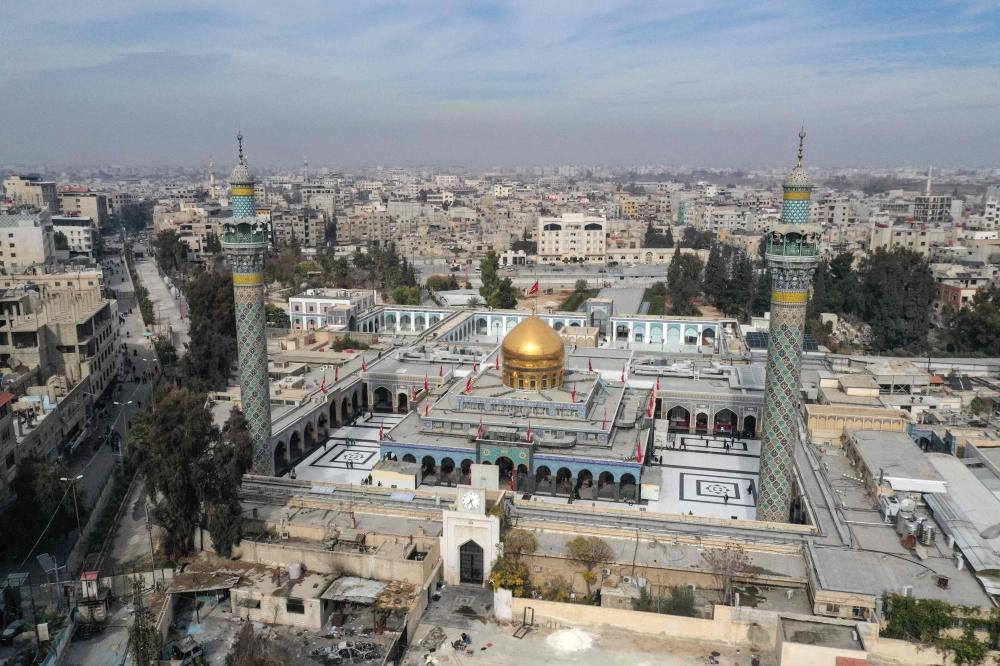 An aerial view shows the shrine of Sayyida Zeinab, locally believed to hold the grave of Zeinab bint Ali, the daughter of Imam Ali and Fatima, and granddaughter of the Islamic prophet Mohammad, in the southern suburbs of Damascus, on December 11, 2024. — AFP pic