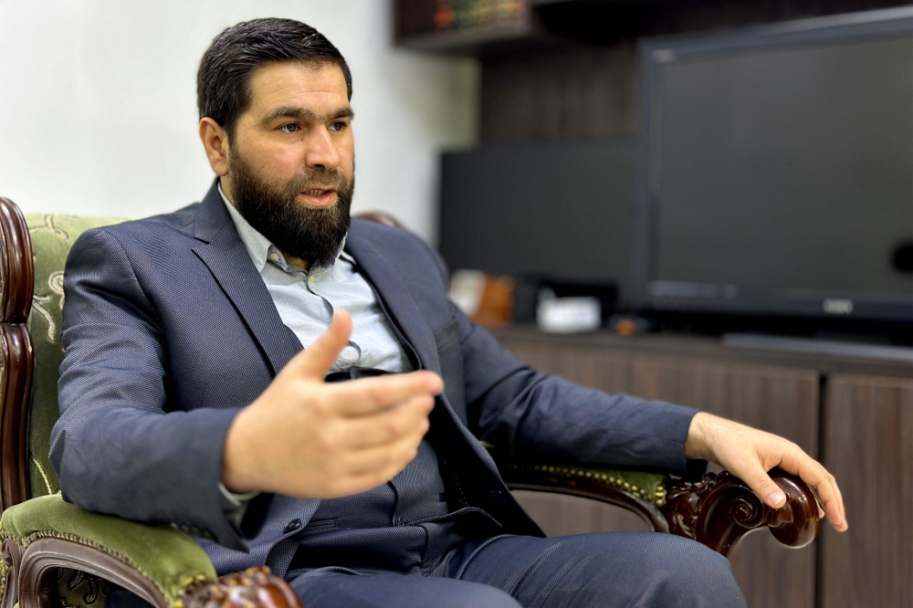 Obeida Arnaout, interim Syrian government’s political affairs spokesman, gives an interview at the headquarters of Syria’s General Organization of Radio and TV (ORTAS) in Damascus on December 12, 2024. Arnaout said that the new government in Syria will ‘freeze the Constitution and Parliament’ during the three-month transitional period. — AFP pic