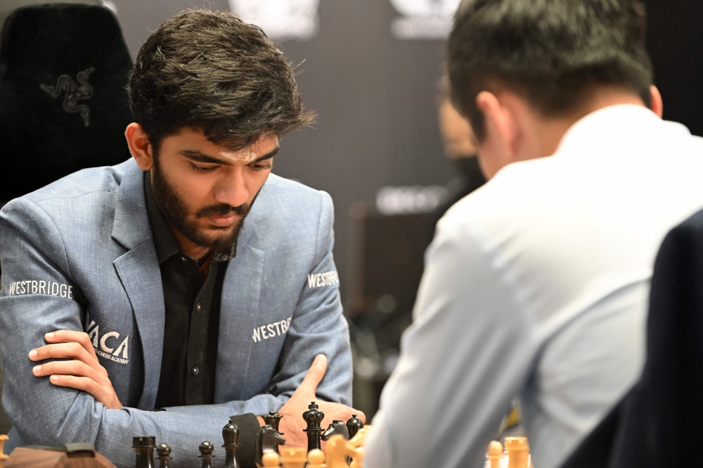 India's grandmaster Gukesh Dommaraju (left) competes against China's chess grandmaster Ding Liren in game 14 of the 2024 FIDE World Championship in Singapore on December 12, 2024. — AFP pic