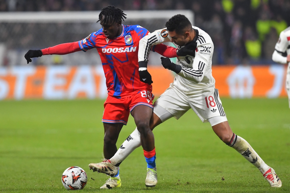 Viktoria Plzen's Ghanaian forward #80 Prince Kwabena Abu (left) and Manchester United's Brazilian midfielder #18 Casemiro vie for the ball during the Uefa Europa League football match between Viktoria Plzen and Manchester United in Plzen, on December 12, 2024. — AFP pic