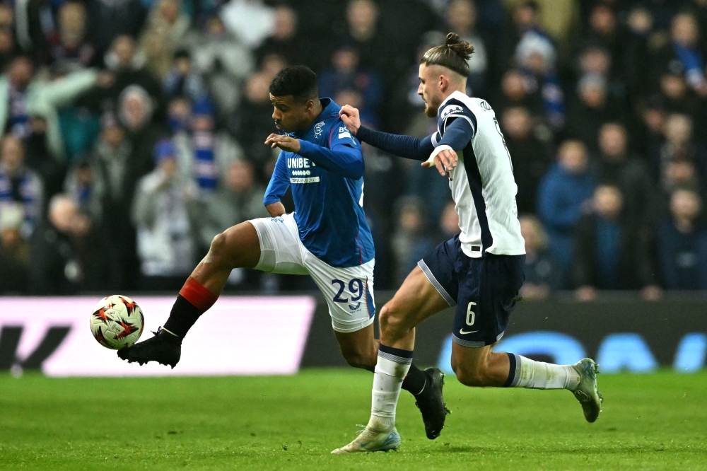Rangers' Moroccan striker #29 Hamza Igamane fights for the ball with Tottenham Hotspur's Romanian defender #06 Radu Dragusin during the Uefa Europa League, League Phase football match between Rangers and Tottenham Hotspur at the Ibrox Stadium in Glasgow December 12, 2024. — AFP pic