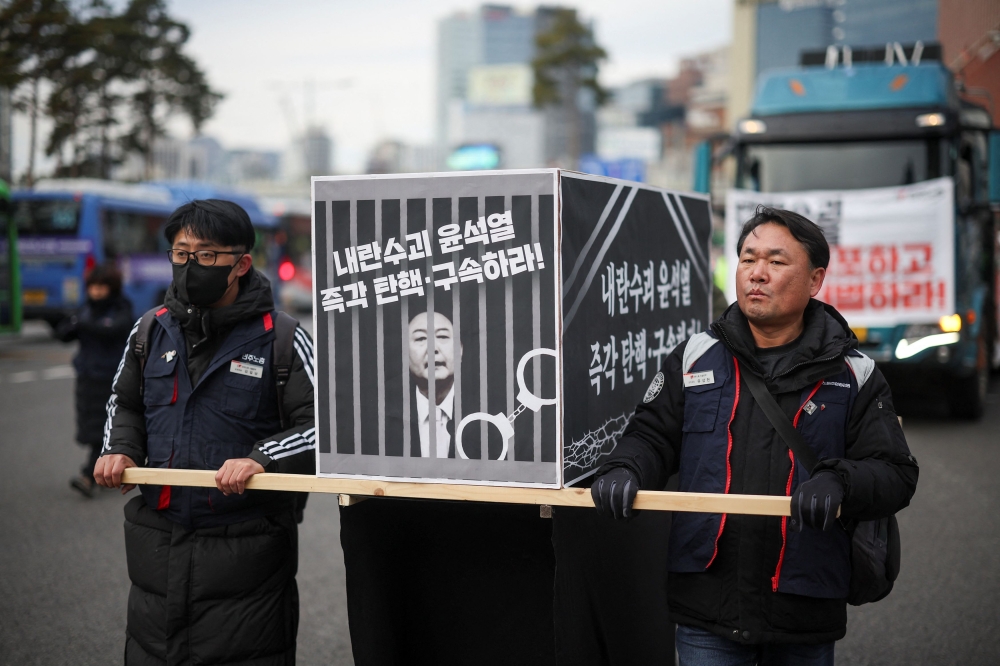 Protesters rally towards the Presidential Office calling for the impeachment of South Korean President Yoon Suk Yeol, who declared martial law, which was reversed hours later, in Seoul, South Korea, December 12, 2024. — Reuters pic