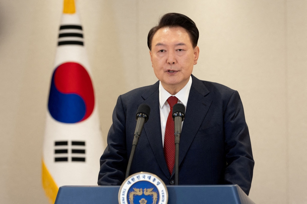 South Korean President Yoon Suk Yeol delivers an address to the nation at the Presidential Office in Seoul December 12, 2024. — The Presidential Office handout pic via Reuters 