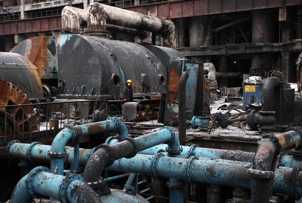 A worker looks up as they repair equipment at a thermal power plant that was damaged during a missile attack, at an undisclosed location in Ukraine, on December 5, 2024, amid the Russian invasion of Ukraine. Ukraine's energy installations were the target of a massive Russian missile attack on December 13, 2024 morning, the Ukrainian authorities announced, with Russia regularly bombarding these infrastructures and causing power cuts across the country at the height of the winter season. — AFP pic
