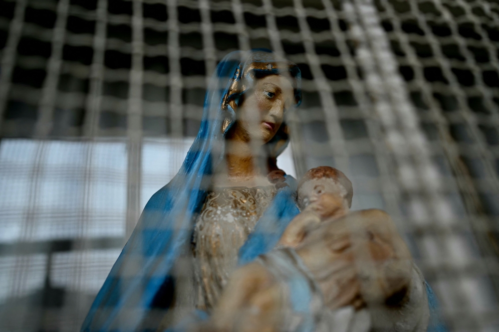 A statue of the Virgin Mary and baby Jesus stands at the site of the Marist Brothers charitable association in Aleppo on December 12, 2024. — AFP pic
