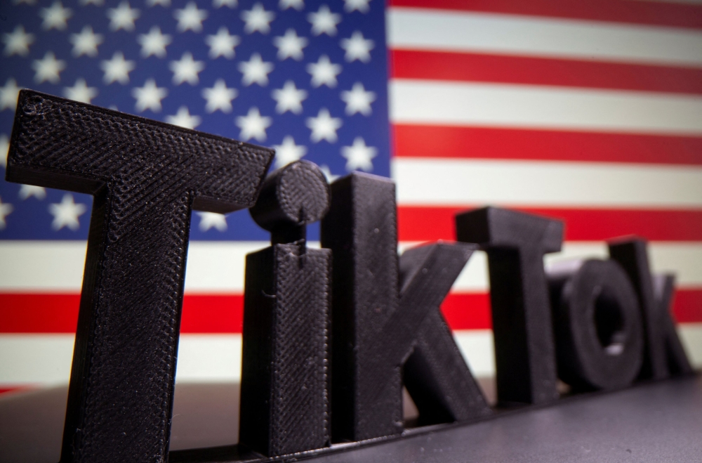 The Tik Tok logo is seen in front of US flag in this illustration taken October 6, 2020. — Reuters pic
