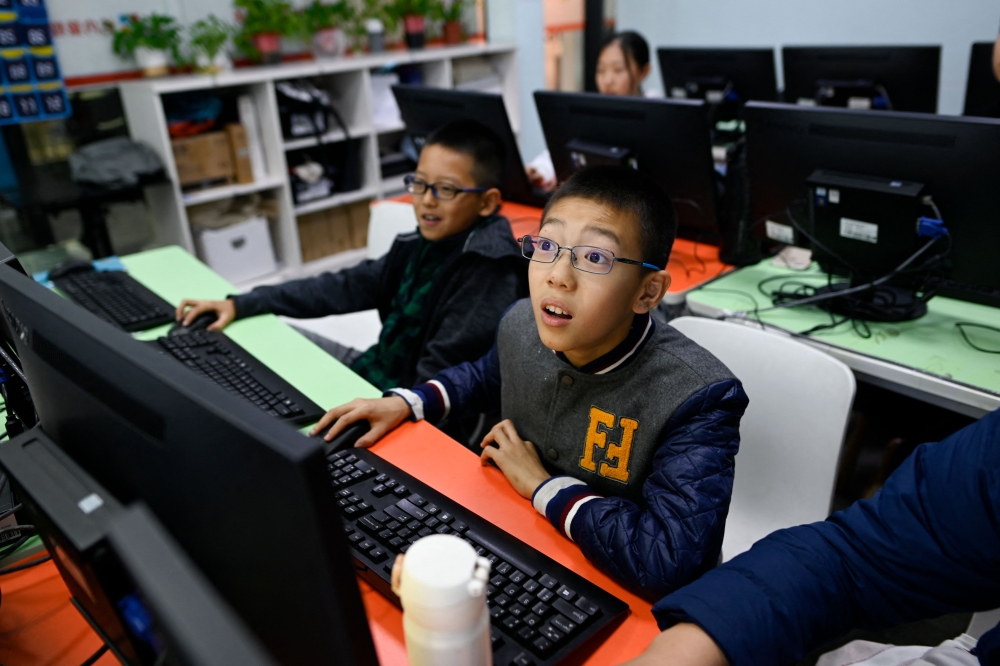 This picture taken on November 8, 2019 shows pupils attending a class at a children's computer coding training centre in Beijing. — AFP pic