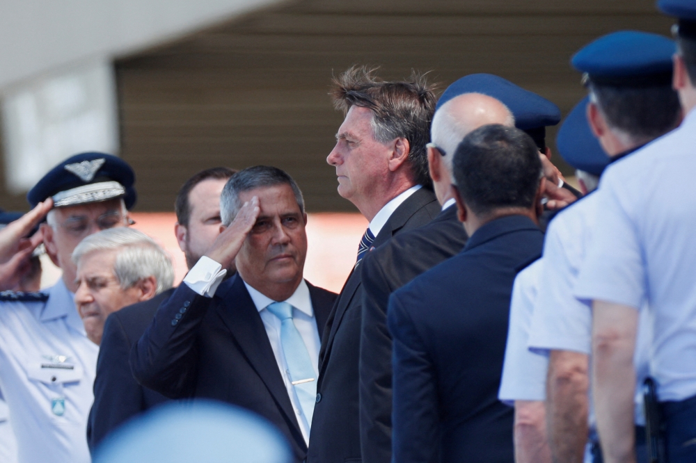 Brazil’s President Jair Bolsonaro looks on, as Brazil’s Defence Minister Walter Souza Braga Netto salutes him, during a military ceremony for the promotion of sergeants from Brazilian Air Force in Brasilia April 1, 2022. — Reuters pic  