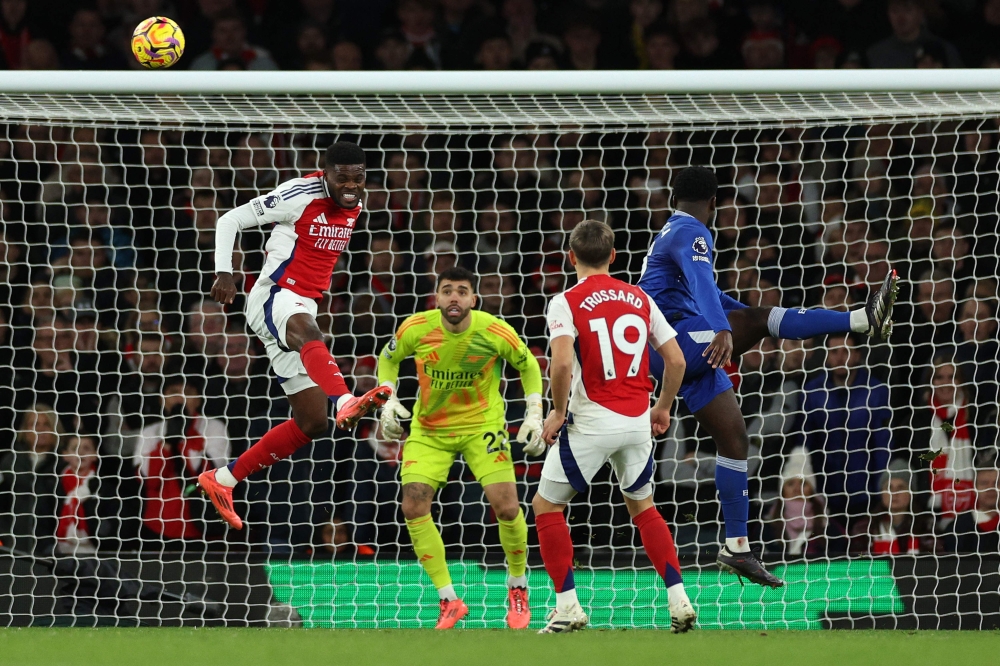 Arsenal’s Thomas Partey heads the ball clear during the English Premier League match with Everton at the Emirates Stadium in London December 14, 2024. — AFP pic