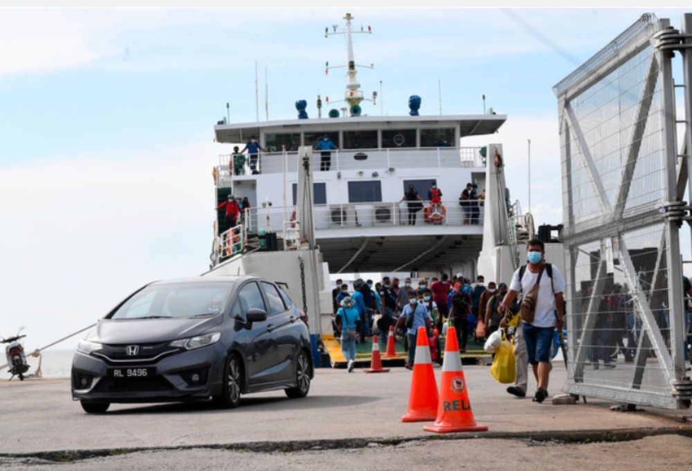 An undated file photograph shows passengers and vehicles disembarking from a ferry to Langkawi. — Bernama pic