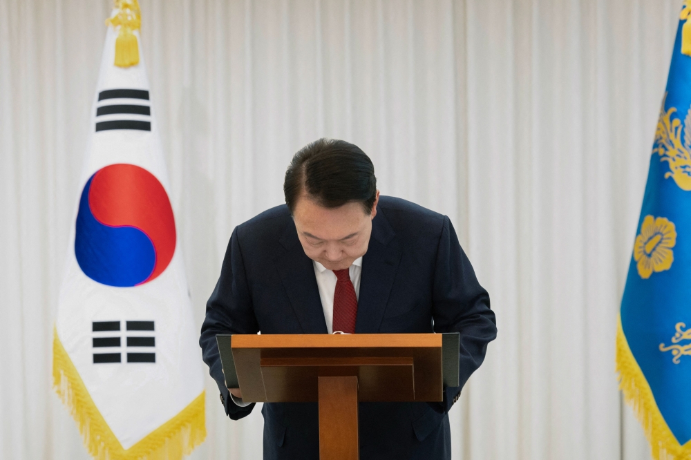 South Korean President Yoon Suk Yeol bows after giving a public address from his official residence in Seoul December 14, 2024. — AFP pic