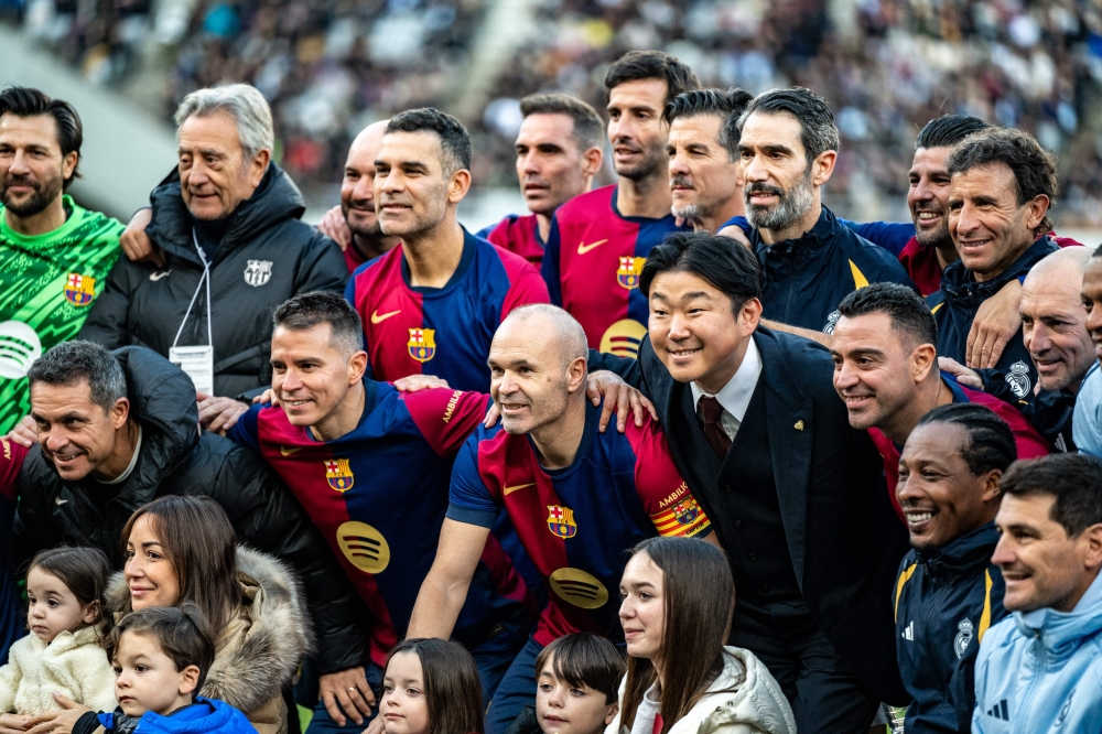 Spanish football legend Andres Iniesta poses for a group photo in his retirement ceremony after the exhibition football match between former Barcelona and Real Madrid players — Barca Legends and Real Madrid Leyendas — at Ajinomoto Stadium in Tokyo December 15, 2024. — AFP pic