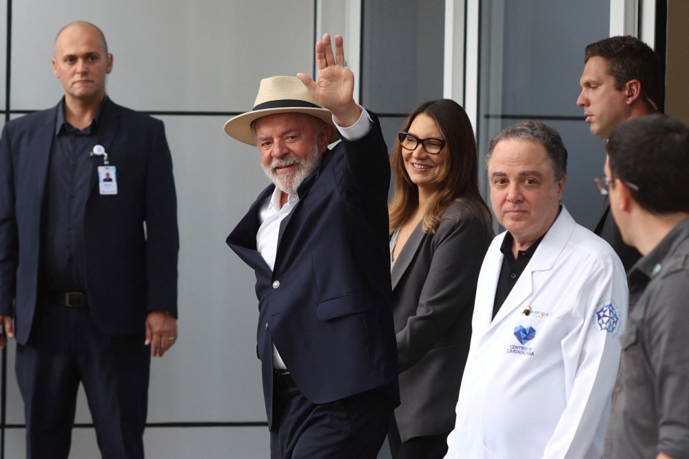 Brazil's President Luiz Inacio Lula da Silva, waves while leaves the Sirio-Libanes Hospital after a surgery, in Sao Paulo, Brazil, December 15, 2024. — Reuters pic