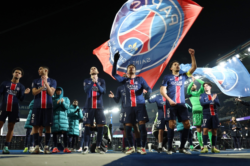 Paris Saint-Germain players celebrate their victory in front of their supporters at the end of the French L1 football match between with Olympique Lyonnais at the Parc des Princes stadium in Paris on December 15, 2024. — AFP pic