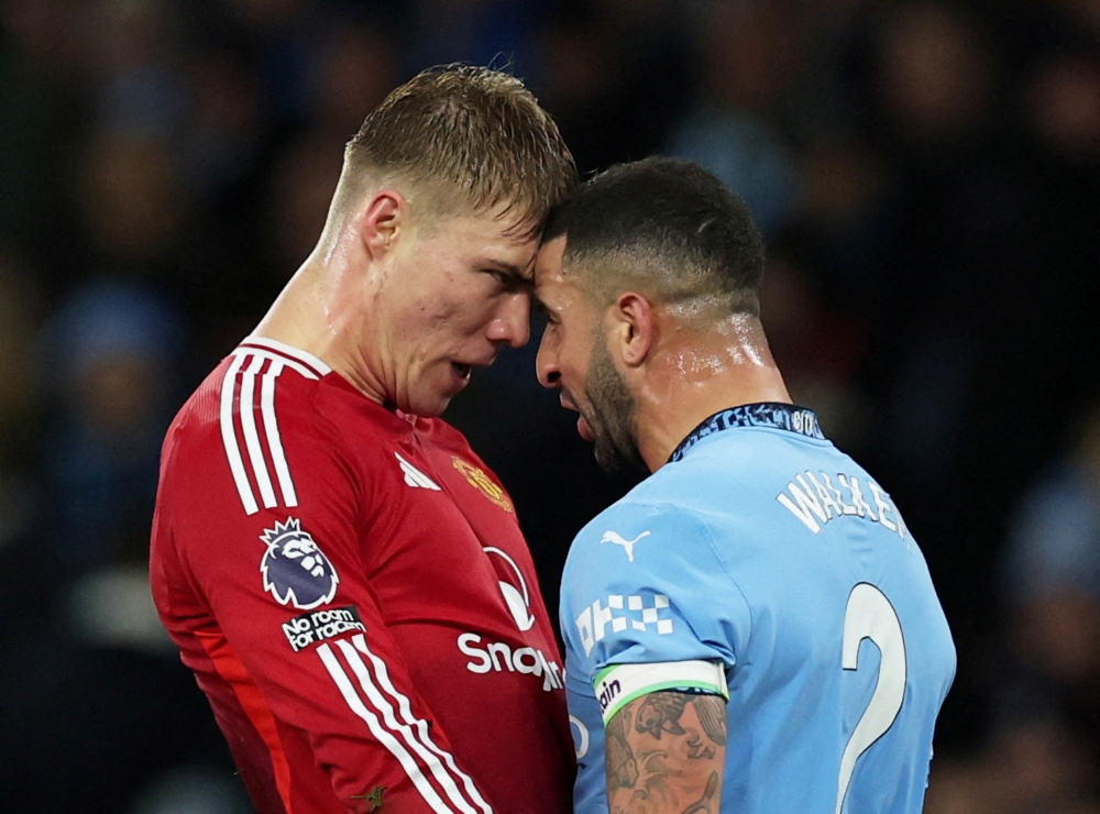Manchester United's Rasmus Hojlund and Manchester City's Kyle Walker clash during their derby. — Reuters pic