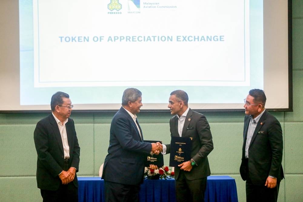 Socso group CEO Datuk Seri Mohammed Azman Aziz Mohammed and Mavcom executive chairman Datuk Seri Saripuddin Kasim exchange documents during the MOU signing ceremony at Wisma Perkeso, December 16, 2024. — Picture by Sayuti Zainudin 