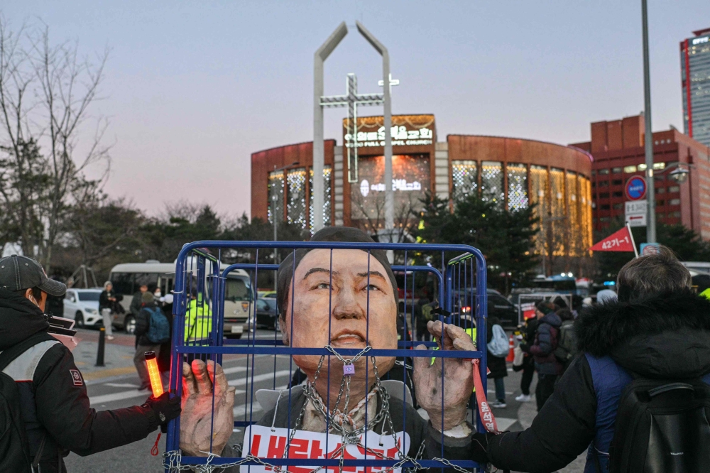 An effigy of South Korean president Yoon Suk-yeol is seen during a protest outside the National Assembly in Seoul on December 14, 2024. — AFP pic