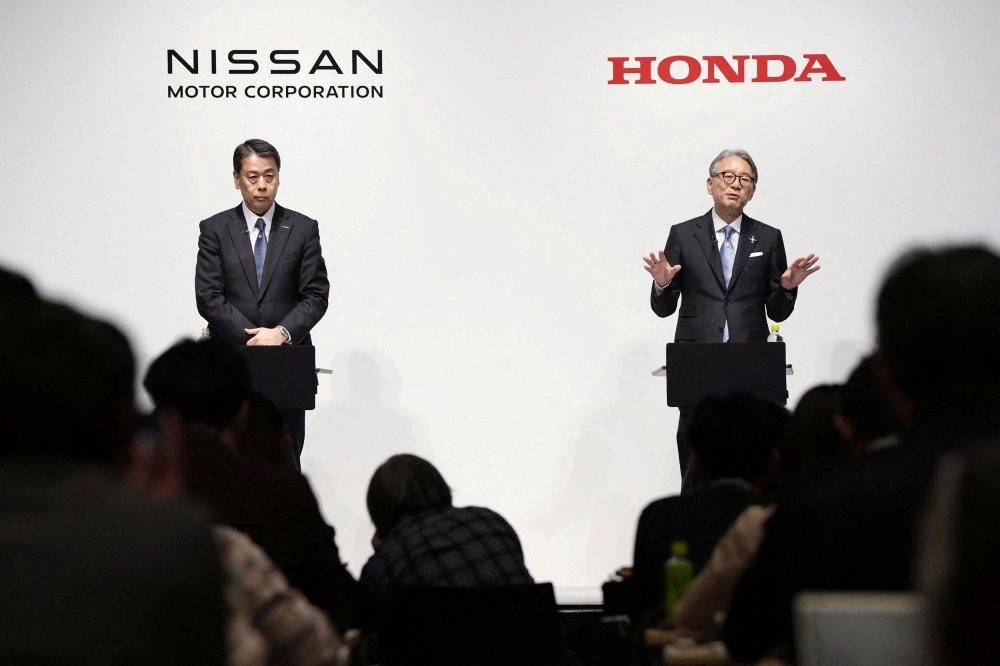 Makoto Uchida, president and CEO of Nissan Motor, and Toshihiro Mibe, Honda Motor president and CEO, attend their joint press conference in Tokyo, Japan March 15, 2024. — Reuters pic