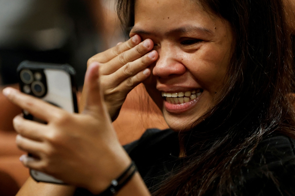 Philippine drug convict and former death row inmate Mary Jane Veloso reacts during a video call at the Soekarno-Hatta Airport in Tangerang, near Jakarta, Indonesia, on December 17, 2024. — Reuters pic
