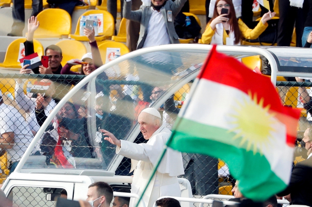A Kurdistan flag is held up as Pope Francis arrives to hold a mass at Franso Hariri Stadium in Erbil, Iraq, March 7, 2021. — Reuters pic