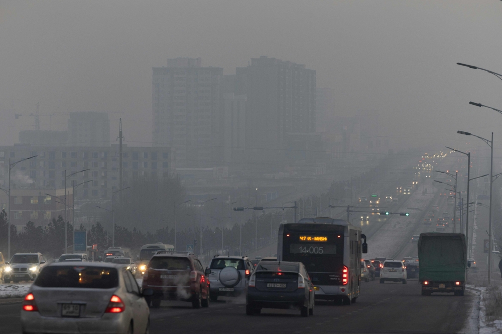 Traffic is seen through thick smog from air pollution shrouding Ulaanbaatar, the capital of Mongolia, on December 16, 2024. — AFP pic