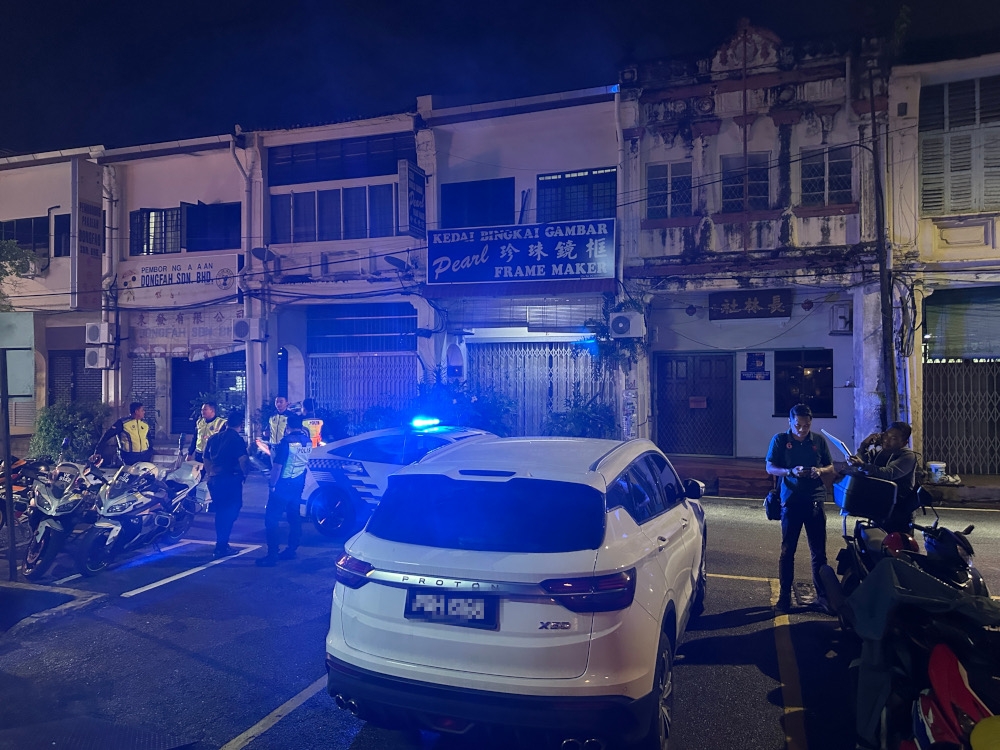 Suaram alleges that police applied pressure by having several officers and a patrol car outside its exhibition venue on Jalan Pintal Tali in George Town, Penang starting from the evening of December 18, 2024. — Picture courtesy of Suaram