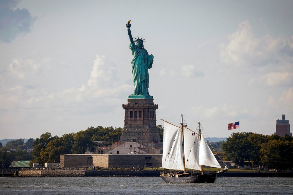 A sailboat passes by the Statue of Liberty in New York Harbor, in New York City September 20, 2024. — Reuters pic  