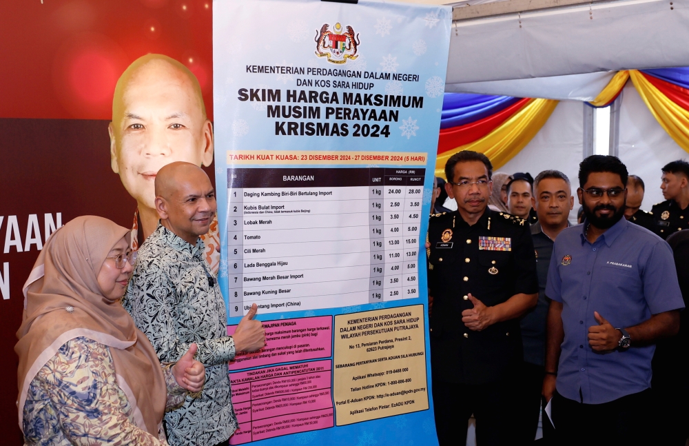 Domestic Trade and Cost of Living Minister Datuk Armizan Mohd Ali (2nd left) displays the list of items under the Festive Season Maximum Price Scheme for Christmas 2024 during its launch, alongside the Rahmah Madani Sales Programme, at UTC Sentul, Bandar Baru Sentul, on December 20, 2024. — Bernama pic