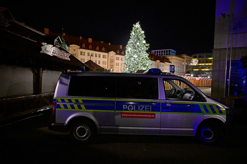 A police car is parked in front of a Christmas market in the eastern Germany city of Magdeburg where a car crashed into a crowd injuring more than 60 people on early December 21, 2024. — AFP pic