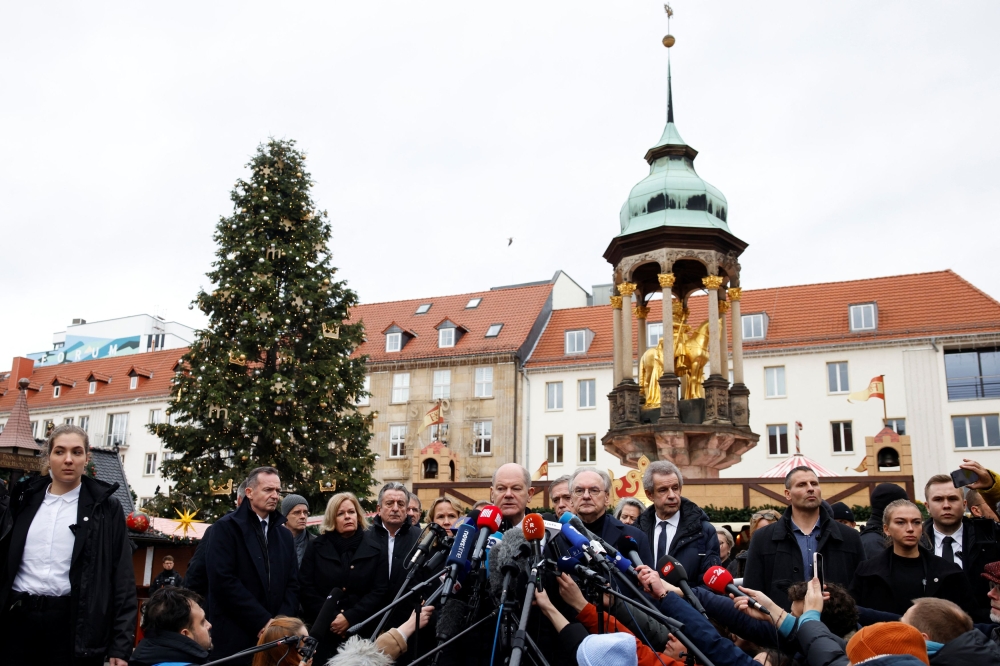 German Chancellor Olaf Scholz speaks to the media during a visit to the site where a car drove into a crowd of a Christmas market in Magdeburg. — Reuters pic