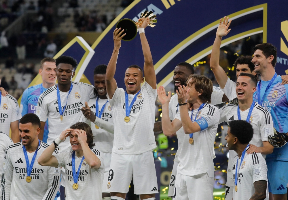 Real Madrid's Kylian Mbappe lifts the trophy as he celebrates with teammates after winning the Intercontinental Cup. — Reuters