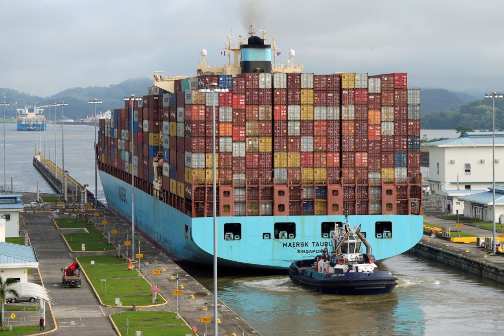 A container ship transits the expanded Panama Canal through the Cocoli Locks. — Reuters pic