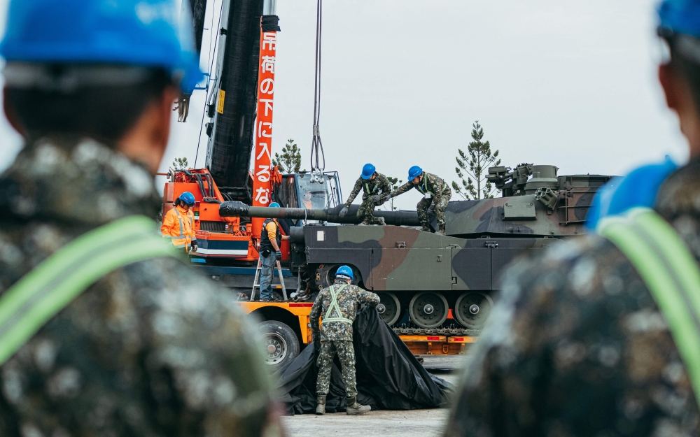 This handout photo taken and released on December 16, 2024 by Taiwan’s Ministry of National Defense shows soldiers securing a US-made M1A2 Abrams battle tank onto a trailer at an army armour training centre in Hsinchu County. — AFP pic/Taiwan’s Ministry of National Defence