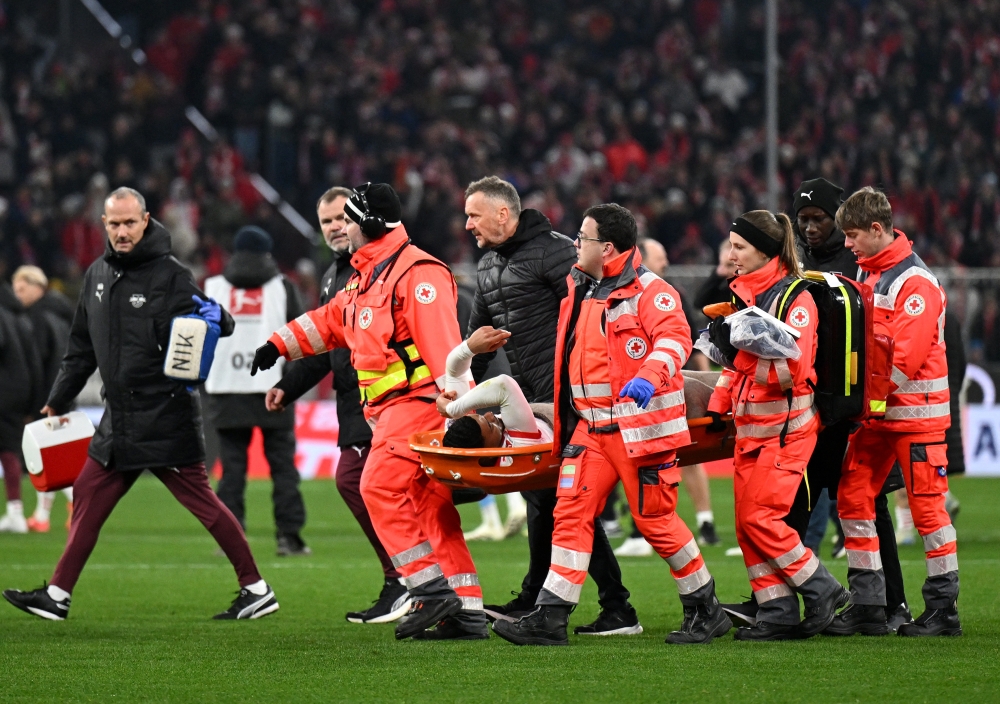 RB Leipzig's Benjamin Henrichs being carried off in a stretcher during Friday's 5-1 loss at Bayern Munich. — Reuters