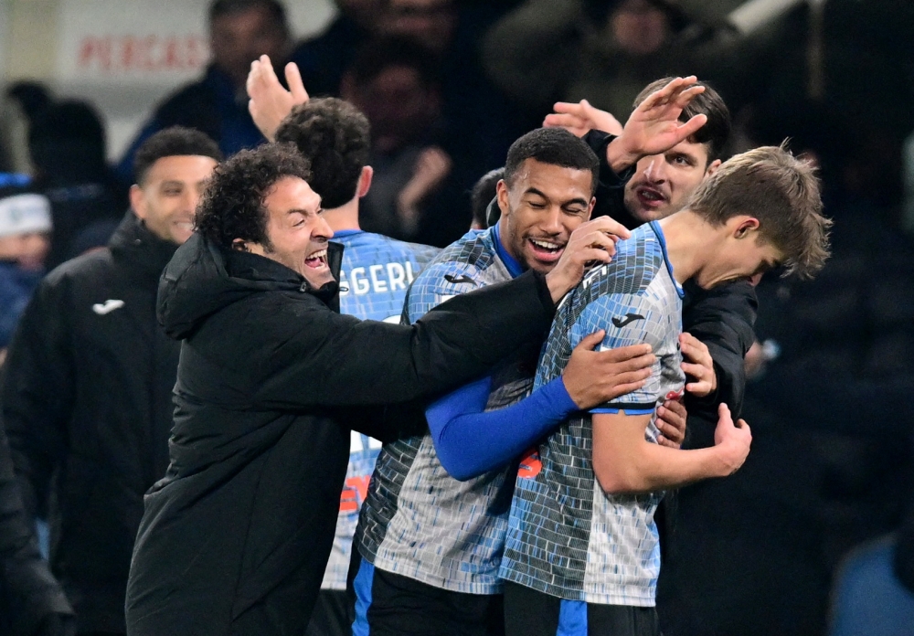 Atalanta's Charles De Ketelaere celebrates scoring their third goal with teammates. — Reuters
