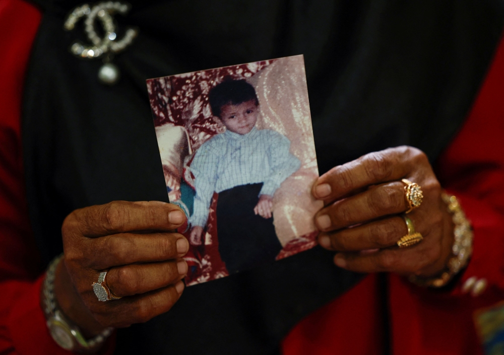 Saudah, a survivor of the Indian Ocean tsunami, shows a photograph of her six-year-old son, Muhammad Siddiq, who she believes is still alive, in Banda Aceh December 21, 2024. — Reuters pic