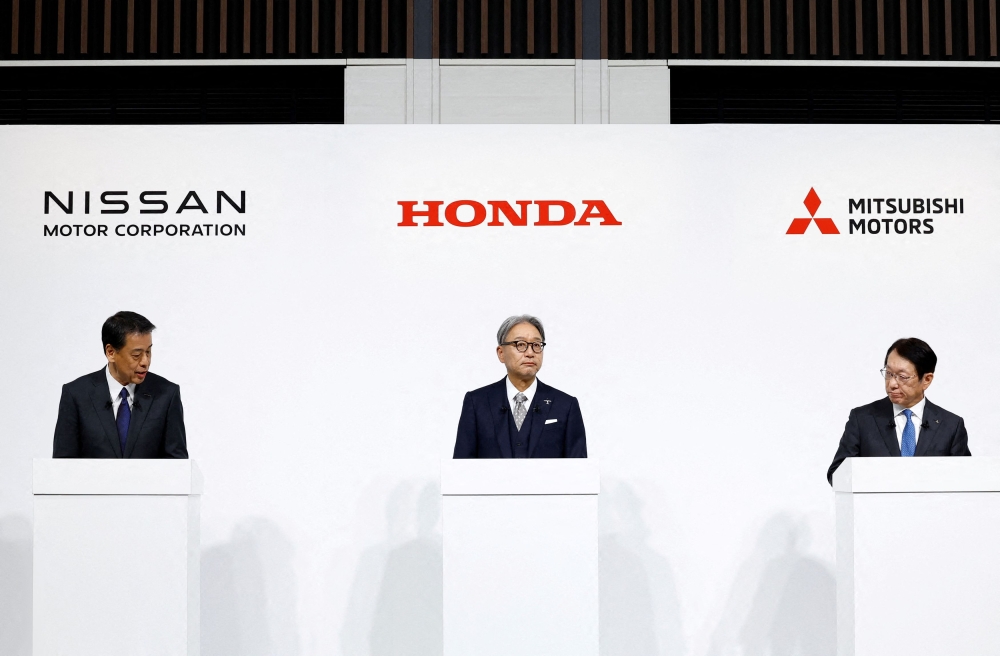 Makoto Uchida, Director, Representative Executive Officer, President and CEO of Nissan Motor Corporation, Toshihiro Mibe, Director, President and Representative Executive Officer of Honda and Takao Kato, Director, Representative Executive Officer, President & CEO of Mitsubishi Motors, hold a joint press conference on their merger talks, in Tokyo, Japan, December 23, 2024. — Reuters pic