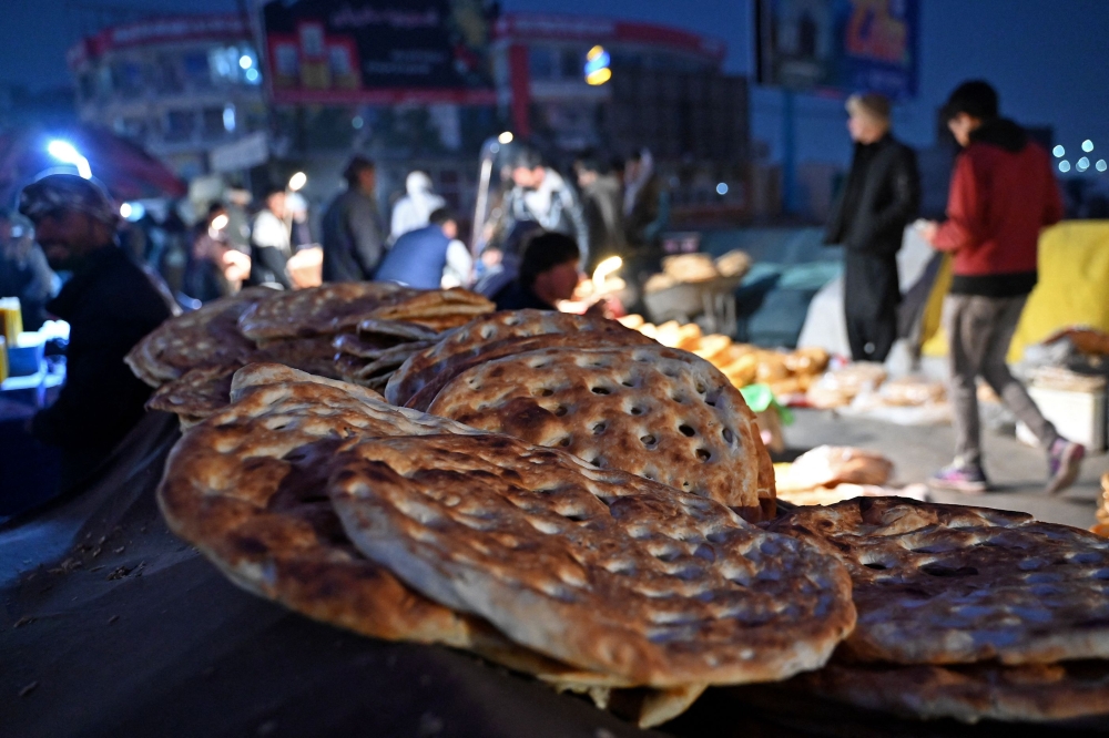 Afghan bread is one of the few foods that everyone can afford, with prices as low as 10 Afghanis (0.14 US cents) to 50 Afghanis. — AFP pic