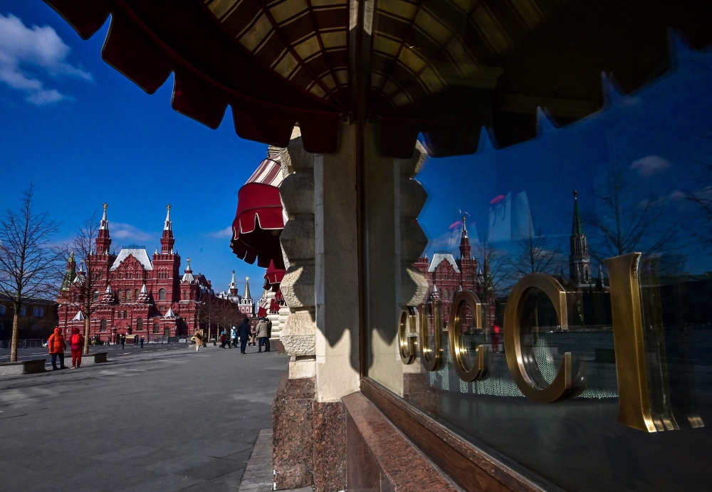 Red Square reflects in the window of the closed Gucci boutique at the GUM department store in central Moscow on March 16, 2022. — AFP pic