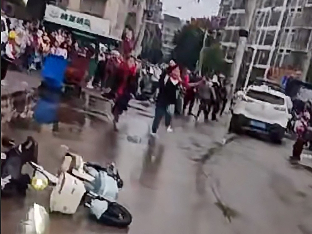 File picture of a frame grab taken from video footage circulating on Chinese social media on November 19, 2024 showing the scene where a car crashed outside the Yong’an primary school in Changde, central China’s Hunan province, in which ‘multiple students were injured’ according to state-run media.—Chinese social media handout pic via AFP
