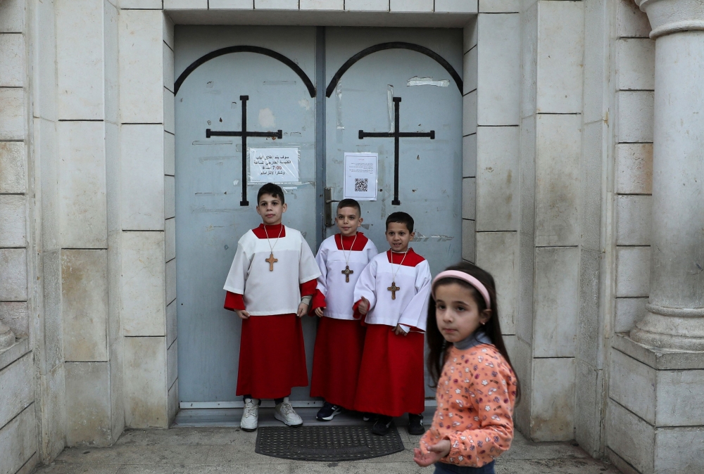 Children stand outside the Holy Family Church on Christmas Eve, amid the Israel-Hamas conflict, in Gaza City, December 24, 2024. — Reuters pic  