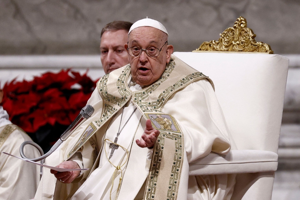 Pope Francis speaks as he celebrates Christmas Eve Mass in St. Peter's Basilica at the Vatican, December 24, 2024. — Reuters pic  