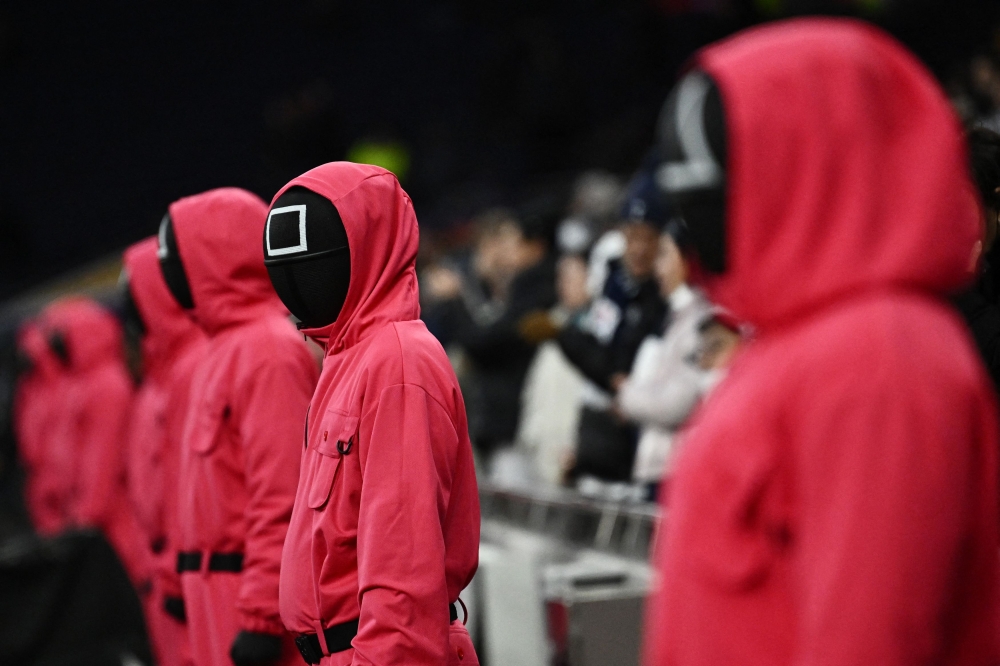 People dressed up as Squid Game characters are seen in the stands before the match between Tottenham Hotspur and Liverpool, December 22, 2024. — Reuters pic