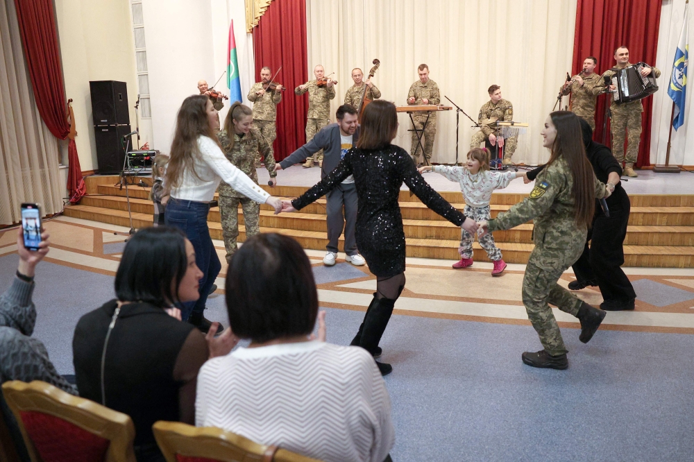 Internally displaced people, members of the diaspora from Bakhmut and National Exemplary Band of the Armed Forces of Ukraine anthem of Ukraine perform during a Christmas concert organised by the exiled Bakhmut city hall in Kyiv, on December 23, 2024. — AFP pic