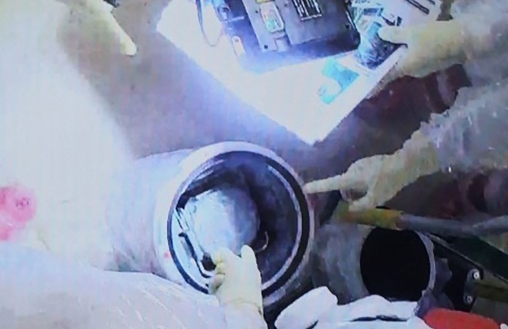 Tokyo Electric Power Company workers loading a transportation box containing fuel debris from Unit 2 into a container, at the Fukushima Daiichi nuclear power plant in Okuma, Japan on November 7, 2024. — Picture by TEPCO via AFP