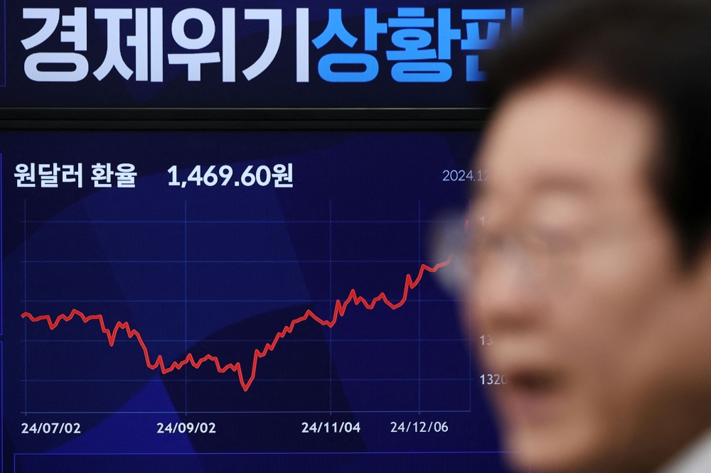 South Korea's opposition Democratic Party leader, Lee Jae-myung, releases a statement to the public as an electronic monitor shows the exchange rate between the US dollar and South Korean won in the background at the National Assembly in Seoul. — Reuters