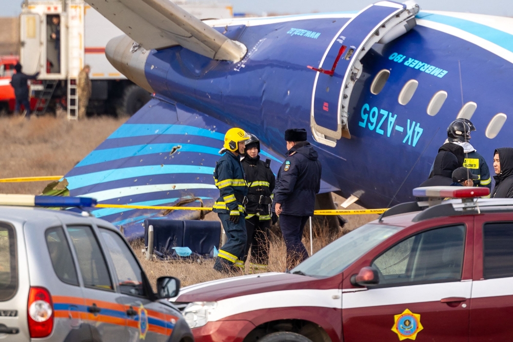 Emergency specialists work at the crash site of an Azerbaijan Airlines passenger jet near the western Kazakh city of Aktau December 25, 2024. Azerbaijan has requested an expert group from Turkiye to investigate the plane crash near Kazakhstan’s Aktau. — AFP pic
